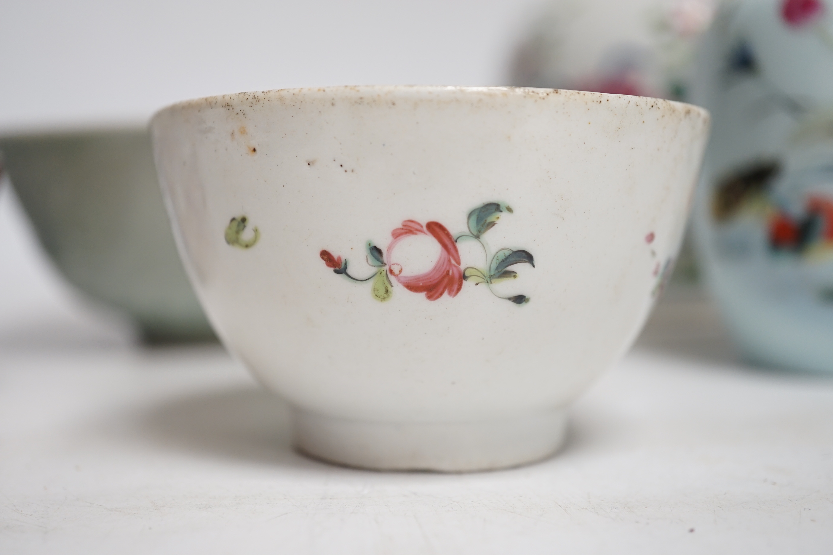 A collection of Chinese ceramics including celadon bowl decorated in low relief with fish, famille rose tea bowls and a jar, largest 12cm high